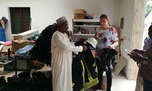 Denise handing over the uniforms